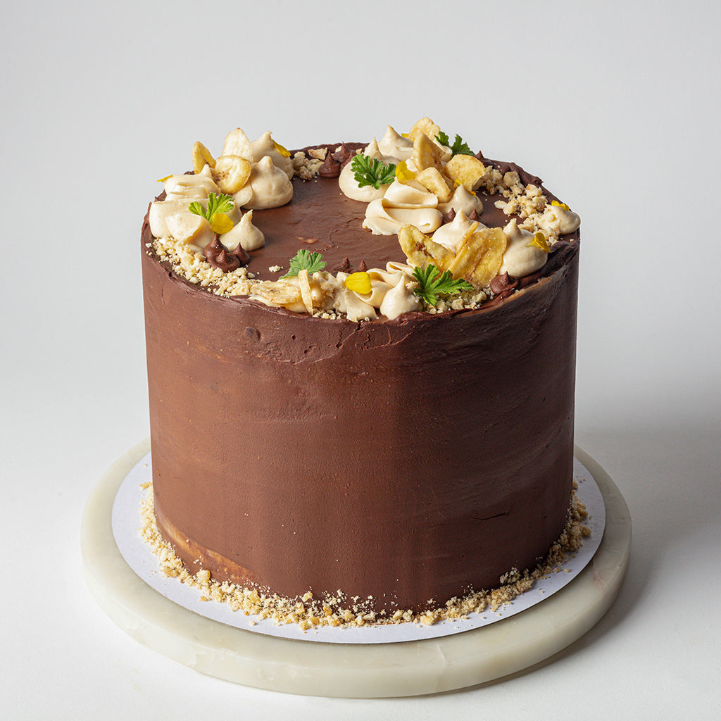 Chocolate Cake with Salted Tahini, Glazed Bananas, Salted Caramel & Dark Chocolate Ganache
